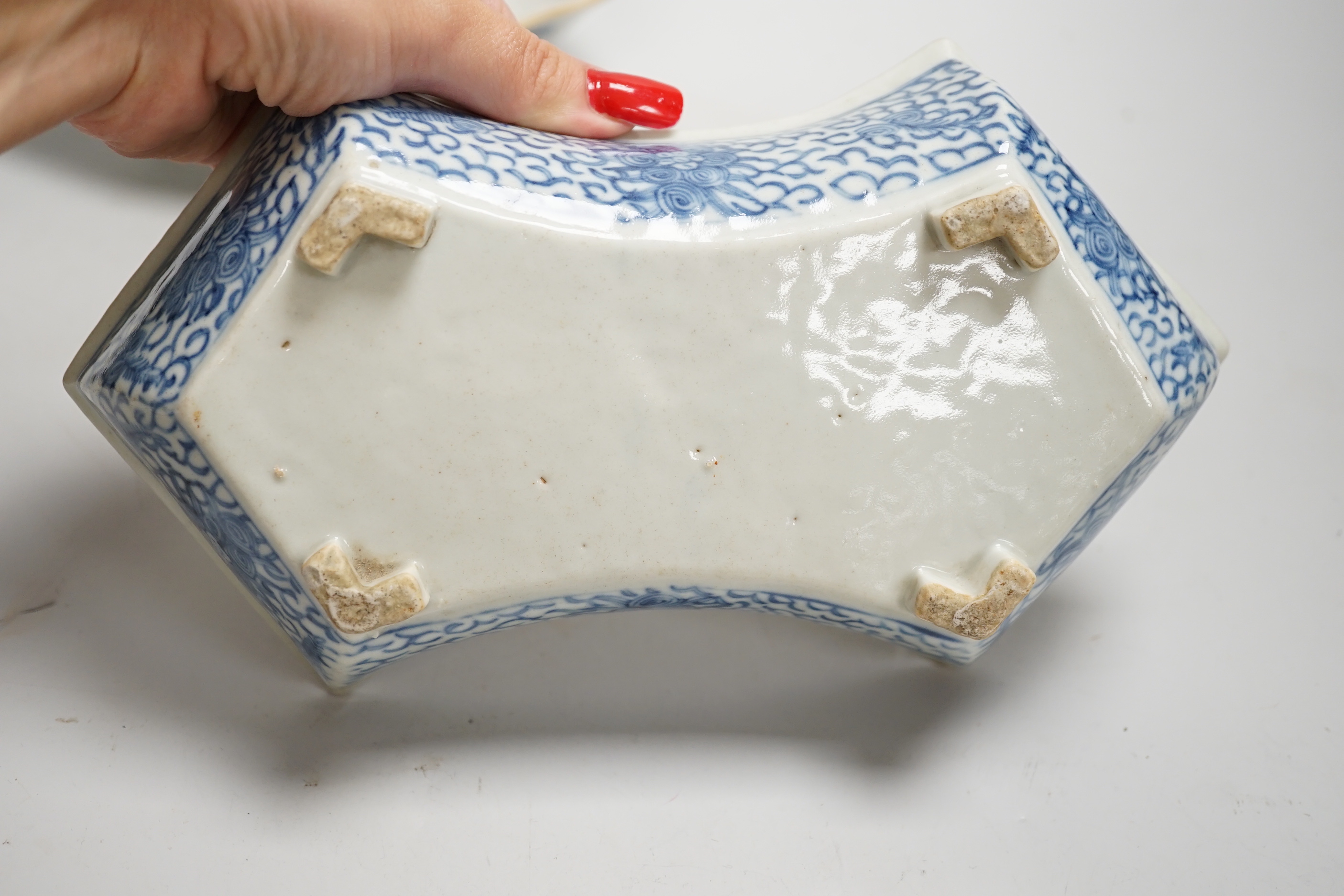 A 19th century Chinese blue and white ingot shaped dish and a famille rose footed dish, the largest 25cm wide (2)